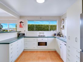 A kitchen with appliances and a window at Lola's - Cambridge Holiday Home in Morrinsville