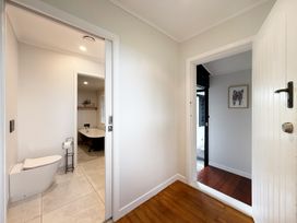 A bathroom with a toilet and bathtub at Country Idyll II – Sandspit Holiday Cottage Warkworth