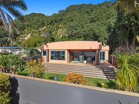 A house with a patio and plants at The Lights House - Beachfront Ohope Holiday Home, Ohope