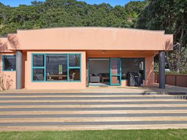 A house exterior with windows and patio at The Lights House - Beachfront Ohope Holiday Home in Ohope