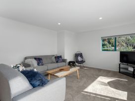 A living room with a sofa and coffee table at The Lights House - Beachfront Ohope Holiday Home Ohope