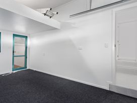 An indoor space with a door and a window at The Lights House - Beachfront Ohope Holiday Home Ohope