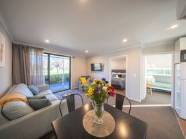 A living room with a sofa and table at Dusky Hunting Unit - Te Anau Holiday Home, Te Anau
