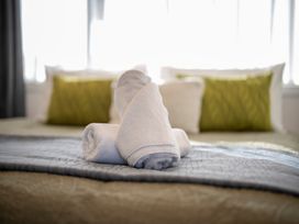 Towels on a bed at Fishing - Te Anau Holiday Home in Te Anau