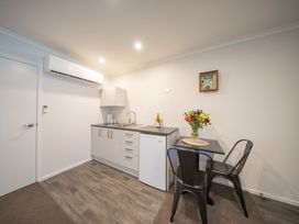 A kitchen with a small table and chairs at Fishing - Te Anau Holiday Home Te Anau