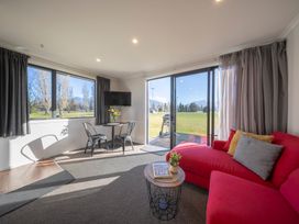 A living room with a sofa and a table at Dusky Rugby Unit - Te Anau Holiday Home, Te Anau