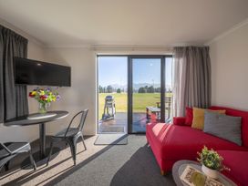 A living room with a television and couch at Dusky Rugby Unit - Te Anau Holiday Home Te Anau