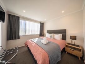 A bedroom with a bed and window at Dusky Rugby Unit - Te Anau Holiday Home in Te Anau