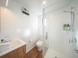 A bathroom with a sink, toilet, and shower at Dusky Rugby Unit - Te Anau Holiday Home, Te Anau