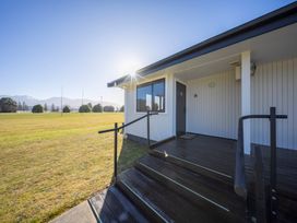 Entrance area with stairs and door at Dusky Rugby Unit - Te Anau Holiday Home Te Anau