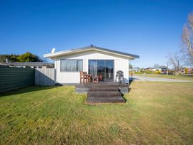A house with a deck and furniture in front at Dusky Rugby Unit - Te Anau Holiday Home Te Anau