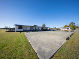 An outdoor area with a building and parking lot at Dusky Rugby Unit - Te Anau Holiday Home Te Anau