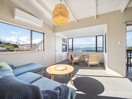A living room with a sofa and a coffee table at Matakana Holiday Home in Warkworth