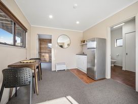 A kitchen with a table and chairs at Matakana Holiday Home in Warkworth