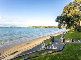 A beach with sand and water at Matakana Holiday Home in Warkworth