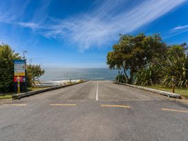 A road leading to the sea with a sign and trees at Hauraki Haven - Lake Taupo Holiday Home, Pukawa