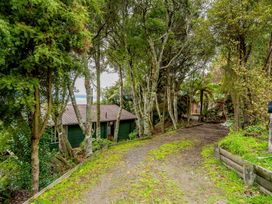 An outdoor area with a pathway and trees at Hauraki Haven - Lake Taupo Holiday Home Pukawa