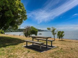 A picnic table near the water at Hauraki Haven - Lake Taupo Holiday Home, Pukawa