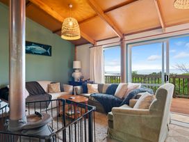 A living room with a sofa and coffee table at Hauraki Haven - Lake Taupo Holiday Home, Pukawa
