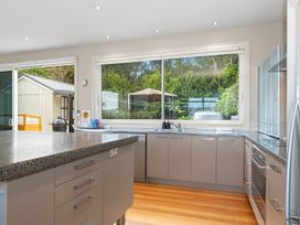 A kitchen with cabinets and a sink at Langs Beach Holiday Home Langs Beach