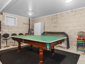 A garage with a pool table and seating at Langs Beach Holiday Home in Langs Beach