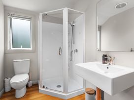 A bathroom with a sink, shower, and toilet at Langs Beach Holiday Home in Langs Beach