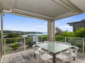 An outdoor patio with a table and chairs at Langs Beach Holiday Home in Langs Beach