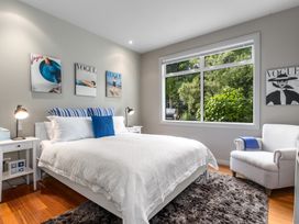 A bedroom with a bed and nightstand at Langs Beach Holiday Home in Langs Beach