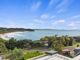 A beach view with waves and trees at Langs Beach Holiday Home in Langs Beach