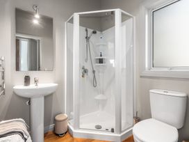 A bathroom with a shower, sink, and toilet at Langs Beach Holiday Home in Langs Beach