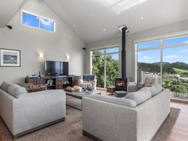 A living room with sofa and television at Langs Beach Holiday Home in Langs Beach