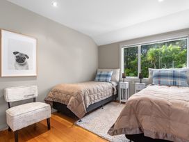 A bedroom with two beds and a photo at Langs Beach Holiday Home in Langs Beach