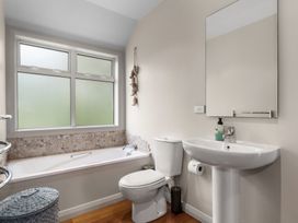 A bathroom with bathtub and sink at Langs Beach Holiday Home in Langs Beach