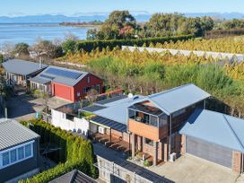 An aerial view of multiple houses and a garage at Roy-Al Retreat - Riwaka Holiday Home Riwaka