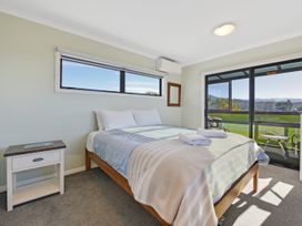 A bedroom with a bed and bedside table at Roy-Al Retreat - Riwaka Holiday Home Riwaka