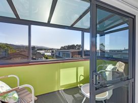A balcony with chairs and a table at Roy-Al Retreat - Riwaka Holiday Home Riwaka