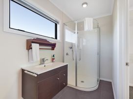 A bathroom with a shower and sink at Roy-Al Retreat - Riwaka Holiday Home in Riwaka