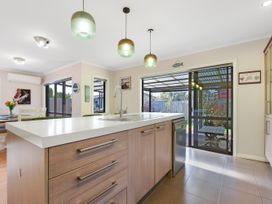 A kitchen with a sink and island at Roy-Al Retreat - Riwaka Holiday Home Riwaka