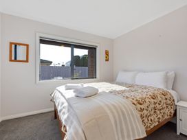 A bedroom with a bed and window at Roy-Al Retreat - Riwaka Holiday Home Riwaka