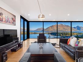 A living room with a television and coffee table at Alpine Haven - Queenstown Villa in Queenstown