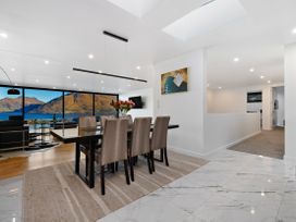 A dining area with chairs and a table at Alpine Haven - Queenstown Villa