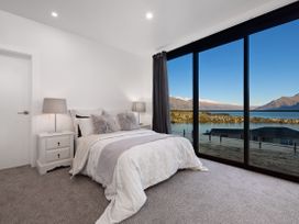 A bedroom with a bed and a bedside table at Alpine Haven - Queenstown Villa in Queenstown