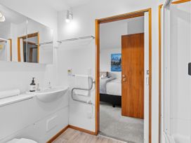 A bathroom with a sink and toilet at Alpine Horizon - Queenstown Holiday Home, Queenstown
