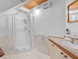 A bathroom with a shower and sink at Alpine Horizon - Queenstown Holiday Home in Queenstown
