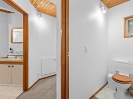 A bathroom with a toilet and sink at Alpine Horizon - Queenstown Holiday Home in Queenstown