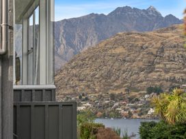 A view of a mountain and lake from a property at Alpine Horizon - Queenstown Holiday Home in Queenstown