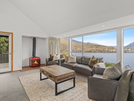 A living room with a sofa and coffee table at Alpine Horizon - Queenstown Holiday Home in Queenstown