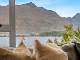 A window view showing mountains, lake, and trees at Alpine Horizon - Queenstown Holiday Home, Queenstown