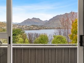 View of mountains and lake from a window at Alpine Horizon - Queenstown Holiday Home in Queenstown