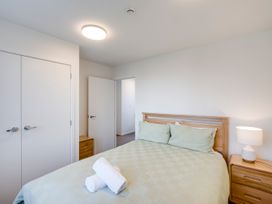 A bedroom with a bed and nightstand at Mayfair Haven - Hastings Holiday Home in Hastings